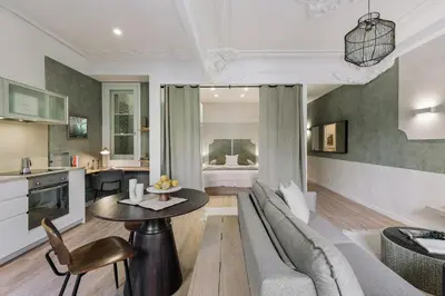 a bedroom with a large bed with two lamps at Paestum - Studio and balcony in Eixample Esquerra in Barcelona