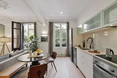 a living room with a couch and a table at Paestum - Studio and balcony in Eixample Esquerra in Barcelona