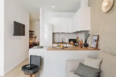 a mirror in a room with a bed and a plant at Tramonti - 2 bedrooms and terrace in Sant Antoni in Barcelona