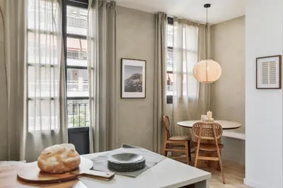 a kitchen with white cabinets and a bowl of fruit on a counter at Tramonti - 2 bedrooms and terrace in Sant Antoni in Barcelona