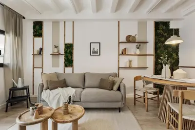 a living room with a couch and a table at Belua - 2 bedrooms in Sarrià in Barcelona