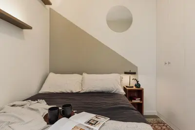 a kitchen with white cabinets and black stools at Pavona - 2 bedrooms and terrace in Sants in Barcelona