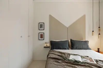 a kitchen with white cabinets and bar stools at Pavona - 2 bedrooms and terrace in Sants in Barcelona
