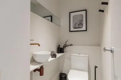 a bathroom with a white toilet and a staircase at Gandoc - 3 bedrooms and terrace in Sants in Barcelona