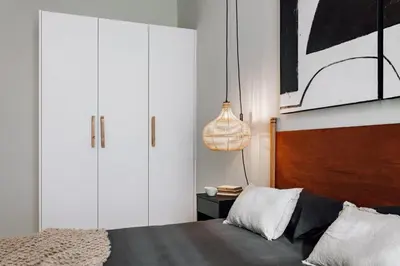 a bedroom with a large bed with two night stands at Feshi - 3 bedrooms in Eixample Dreta in Barcelona