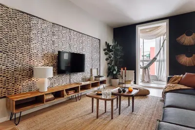 a living room with a tv on a wall at Feshi - 3 bedrooms in Eixample Dreta in Barcelona