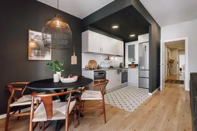 a kitchen and dining room with a table and chairs at Feshi - 3 bedrooms in Eixample Dreta in Barcelona