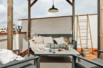 a bedroom with a large white bed with two lamps at Remy - 2 bedrooms and terrace in Eixample Dreta in Barcelona