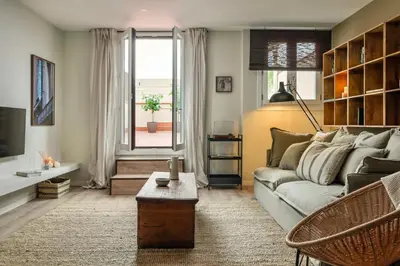 a living room with a couch and a table at Remy - 2 bedrooms and terrace in Eixample Dreta in Barcelona