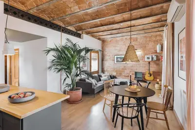 a patio with a couch and tables and plants at Rio Doce - 1 bedroom and terrace in Gòtic in Barcelona