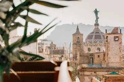 a table and chairs on a patio with plants at Rio Doce - 1 bedroom and terrace in Gòtic in Barcelona