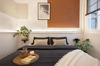 a bedroom with a bed with a table with a book at Haku - 3 bedrooms in Eixample Dreta in Barcelona