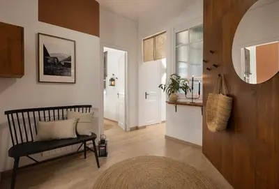 a living room with a bench and a mirror at Haku - 3 bedrooms in Eixample Dreta in Barcelona