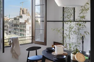 a dining room with a table and chairs and a window at Haku - 3 bedrooms in Eixample Dreta in Barcelona