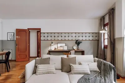 a bedroom with a large bed and a mirror at Cortijo - 2 bedrooms in Gràcia in Barcelona
