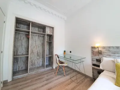 a room with a desk and a bed and a window at DreamKeys Barcelona City in Barcelona