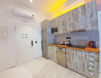 a kitchen with wooden cabinets and a counter top at DreamKeys Barcelona City in Barcelona