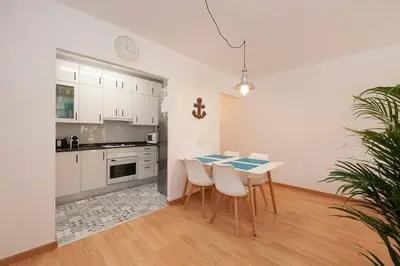 a kitchen with a table and chairs in a room at Beach vibes in Castelldefels in Castelldefels