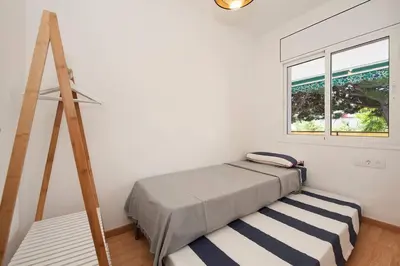 a bedroom with a bed and a window at Beach vibes in Castelldefels in Castelldefels