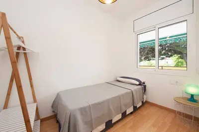 a bedroom with a bed and a window at Beach vibes in Castelldefels in Castelldefels