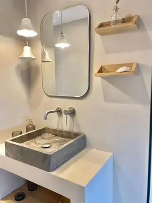 a bathroom with a concrete sink and a mirror at New penthouse duplex by the sea in Masnou