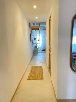 a hallway with a rug on the floor of a house at New penthouse duplex by the sea in Masnou
