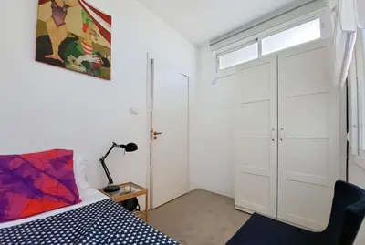 a bedroom with a bed and a window and a door at Flateli Rossello 134 in Barcelona