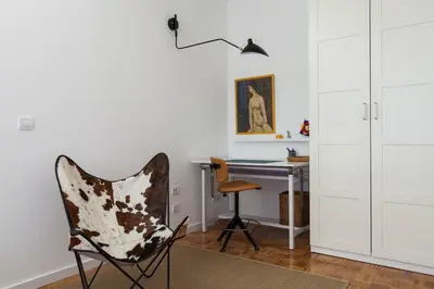 a chair in a room with a desk and a lamp at Flateli Rossello 134 in Barcelona