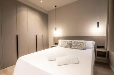 a bedroom with a large white bed with two pillows at Sagrada família essence in Barcelona