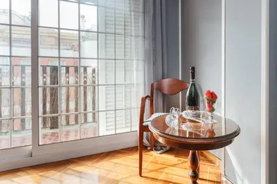a table with a bottle of wine and a glass at Matarolux 2 in Mataró