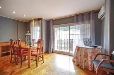 a dining room with a table and chairs and a window at Matarolux 2 in Mataró