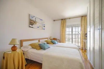 a bedroom with two beds and a window at Matarolux 2 in Mataró
