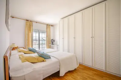 a bedroom with a bed with pillows and a window at Matarolux 2 in Mataró