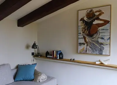 a living room with a painting on the wall at Pergola Suite - Boutique Retreat Loft Barcelona Coast Panoramic Sea View in Sant Andreu de Llavaneres