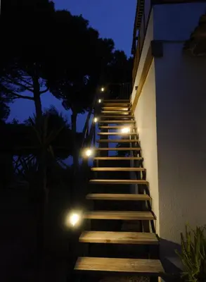 a set of stairs with lights on the side of a building at Pergola Suite - Boutique Retreat Loft Barcelona Coast Panoramic Sea View in Sant Andreu de Llavaneres