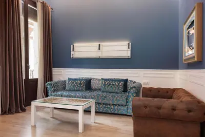a blue living room with a couch and a table at Colon Deluxe con Piscina cerca del Mar in Barcelona