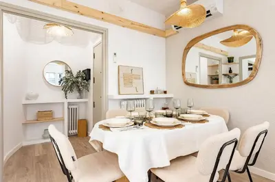 a dining room with a table and a mirror at Barcelona Central Charm with Mediterranean Vibes in Barcelona