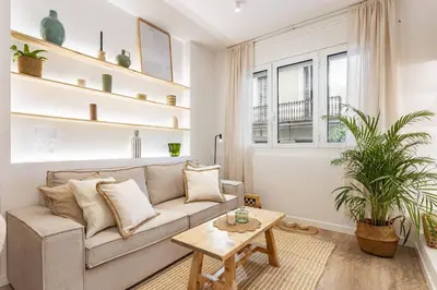 a living room with a couch and a table at Barcelona Central Charm with Mediterranean Vibes in Barcelona