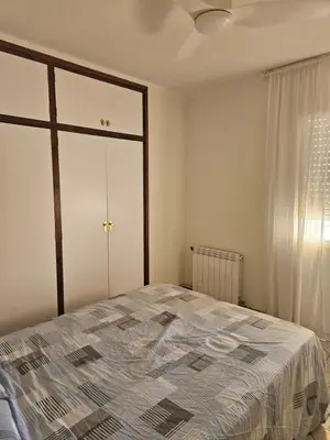 a bedroom with a large bed and a window at Apartamento Luminoso en el Centro de Sitges in Sitges