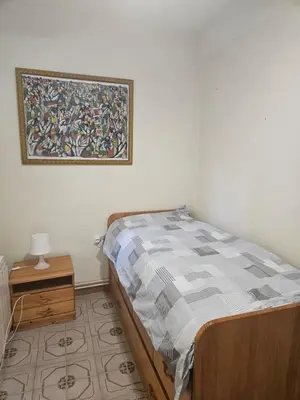 a bedroom with a bed and a picture on the wall at Apartamento Luminoso en el Centro de Sitges in Sitges