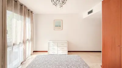 a white room with a dresser and a window at Villa Marina in Sitges