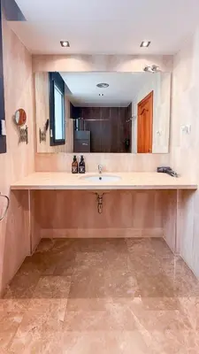 a bathroom with a sink and a large mirror at Villa Marina in Sitges