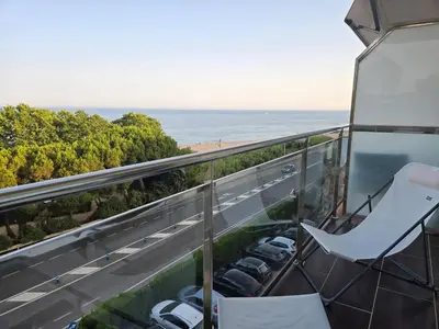 a balcony with cars parked on a road and the ocean at Aquamarina Apt | Seaviews | 1' beach | Family in San Pol de Mar
