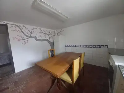 a small room with a table and a tree on the wall at Hostal Rural Mas Blanc in San Martín de Centellas