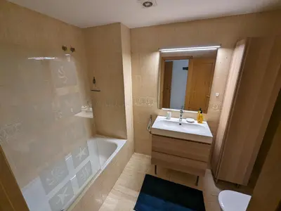 a bathroom with a sink and a shower and a tub at Large and calm 3 bedroom apartment with terrace in Barcelona