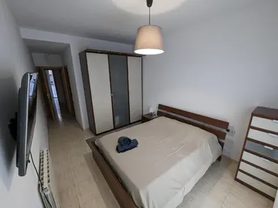 a bedroom with a bed with a blue hat on it at Large and calm 3 bedroom apartment with terrace in Barcelona