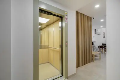 a glass door in a hallway with a table at Hotel Plini in Hospitalet de Llobregat