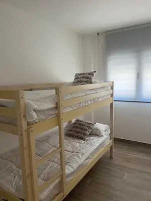 two bunk beds in a room with a window at Tr3sor B2 in Calella