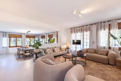 a living room with a couch and a table at Villa Carmen - Peaceful Eco-Luxury with private pool in Cunit