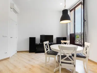 a dining room with a white table and chairs at Canela Homes MIDTERM MARINA in Barcelona